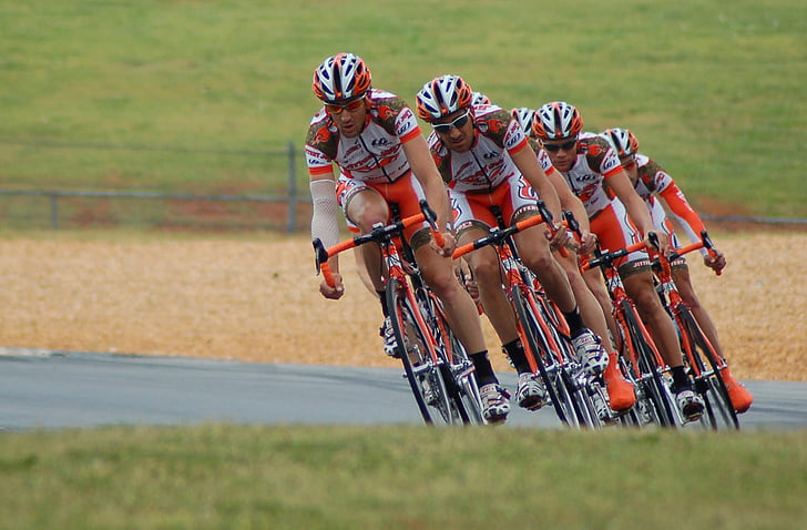 four men riding bicycle on race