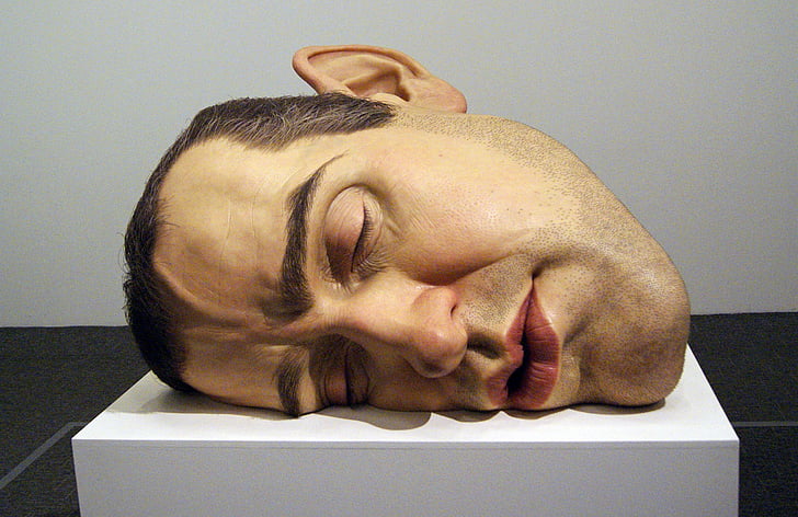 person's head on top of white surface