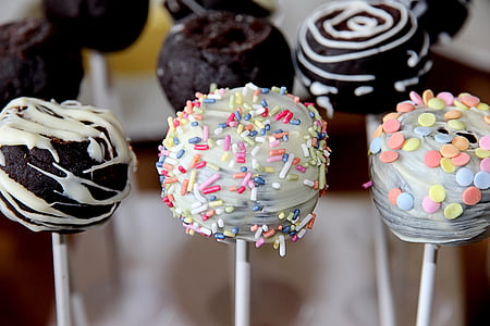 assorted flavored lollipop with springkles and cream toppings