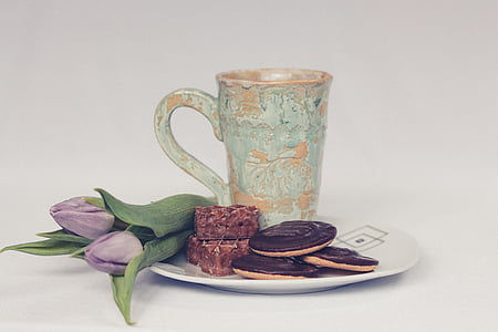 cookie and teacup on plate with flower