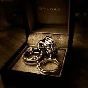 three silver-colored Bvlgari rings with box in til shift photography