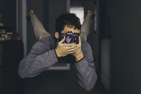 man holding camera taking photo while floating