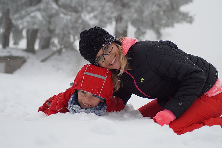 mother and child playing in the snow
