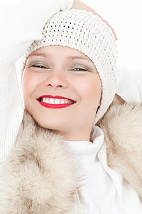 woman wearing white knit hat and white fur-lined coat