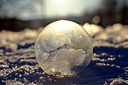 focus photo of round clear glass ball