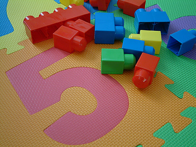 assorted-colored interlock toys on jigsaw mat