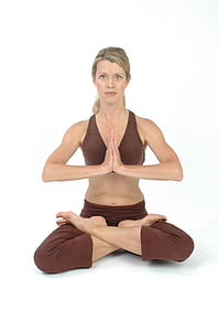 woman with brown yoga suit doing lotus position