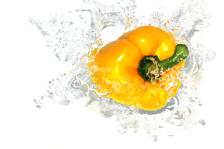 macro photography of yellow bell pepper with water splash