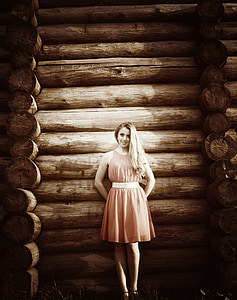 woman standing on tree log wall