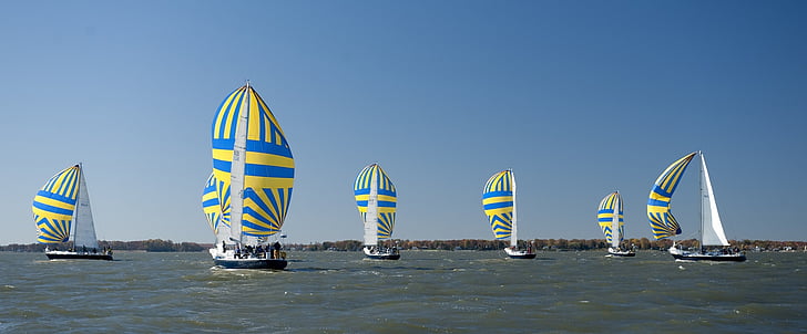 blue-and-yellow sailboats on body of water