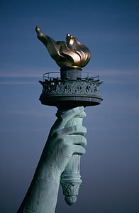 statue of liberty torch photography during daytime