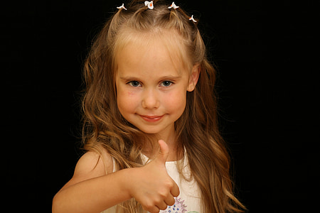 girl wearing white tank top raising her thumb while taking photo