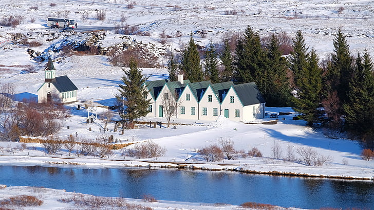 five white houses near a river in snow terrain