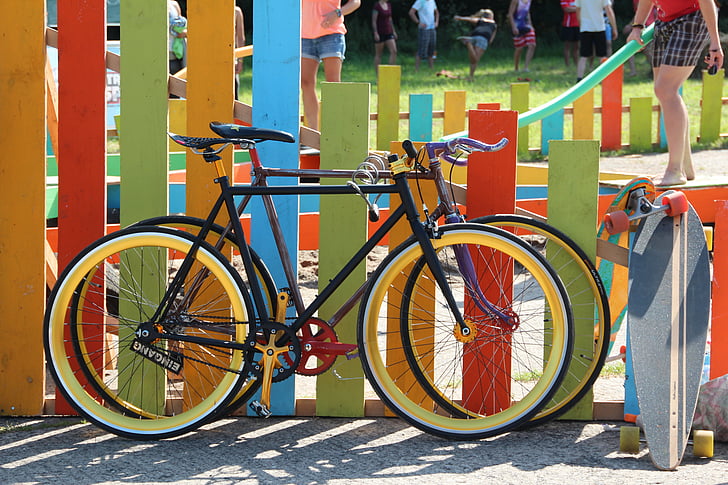 two bicycles parked beside fence