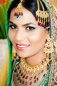 woman wearing gold-colored red and blue gemstone jewelries