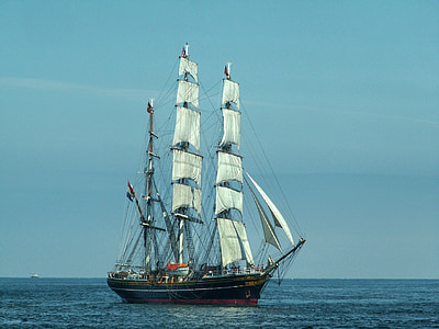 white and black sailing ship on sea