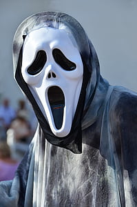 person wearing Ghostface mask