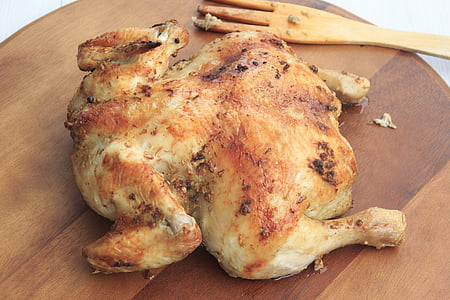grilled chicken on brown wooden tray
