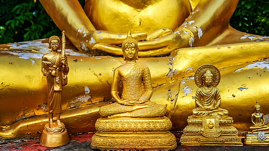 four assorted-sized of Buddha figurines
