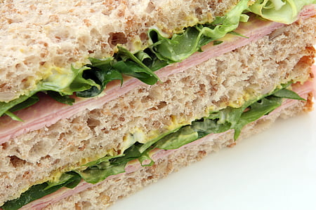 close-up photo of ham sandwich filled with lettuce