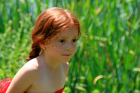 selective focus photography of girl in red strapless dress