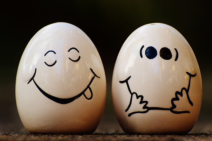 selective focus photography of two ceramic egg figurines