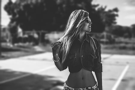 grayscale photo of woman in crop top and bottoms with sunglasses