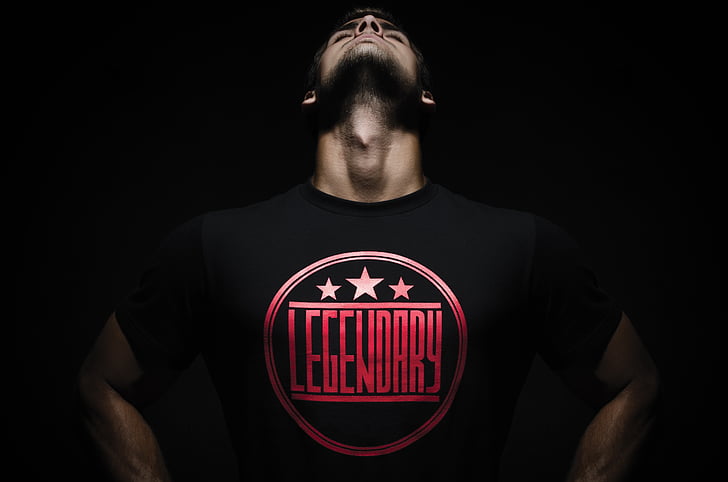 man in black and red Legendary-printed crew-neck shirt