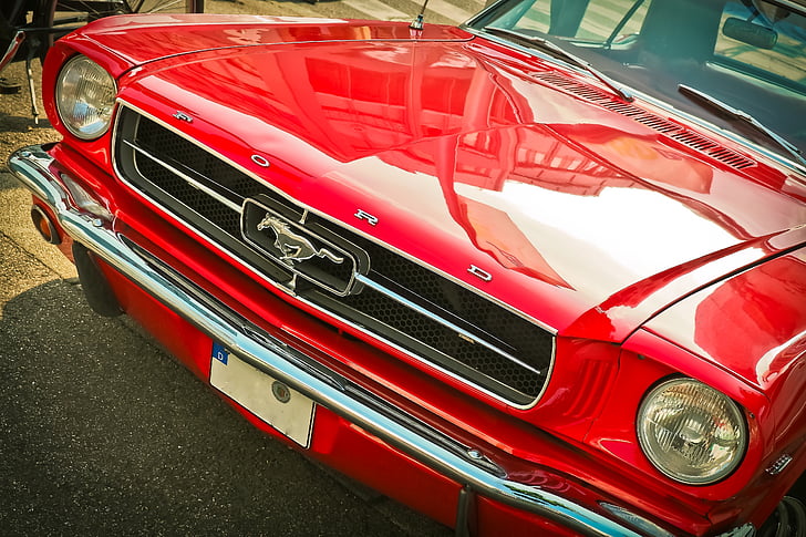 selective focus photo of red Ford Mustang coupe