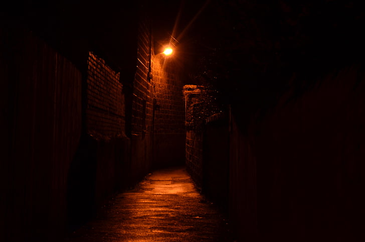 photo of gray concrete pathway with turned on light at nighttime