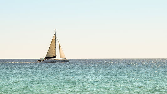 photo of white and beige sailboat during daytime