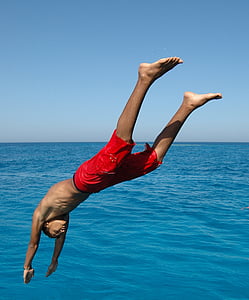 man about to dive at body of water