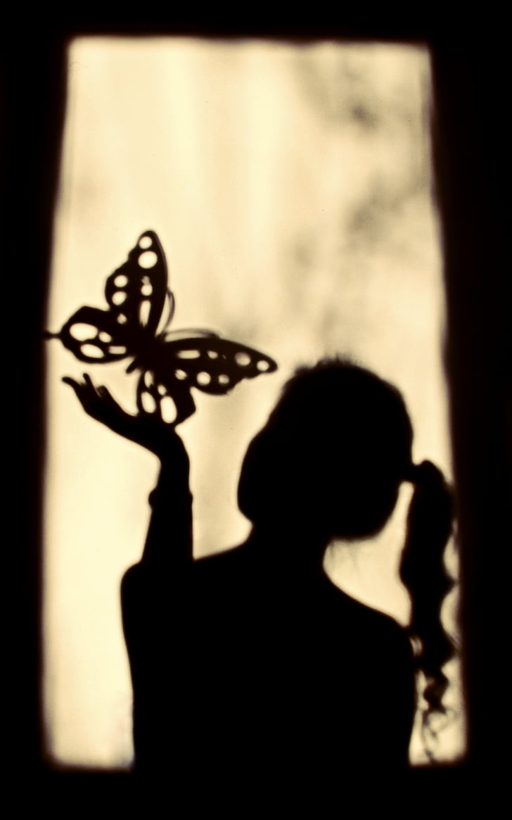 Royalty-Free photo: Woman holding butterfly sand art - PickPik