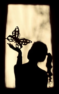woman holding butterfly sand art