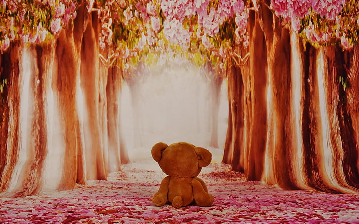 brown bear plush toy between trees