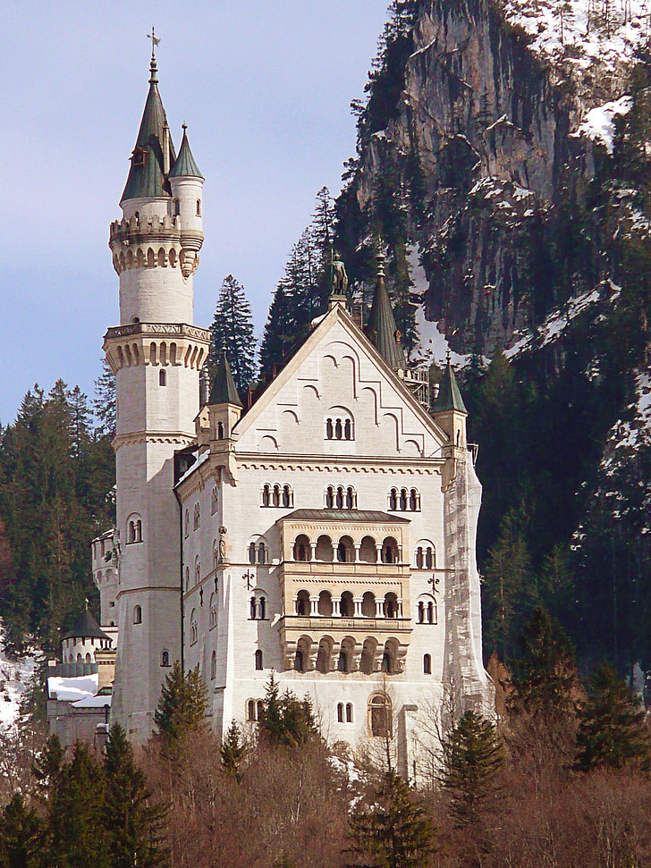 white and beige castle near mountain