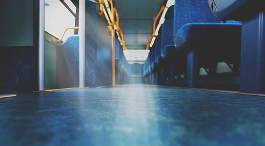 low angle photography of blue vehicle seats inside bus