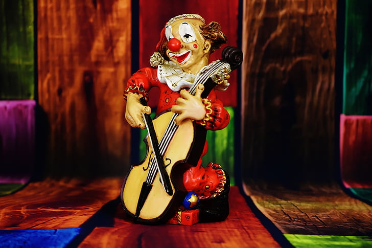 clown playing cello figurine