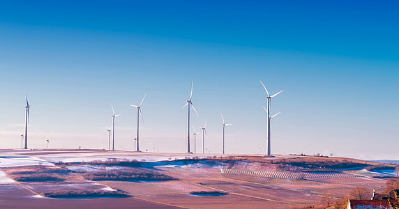 landscape photo of white energy generating windmills during daytime