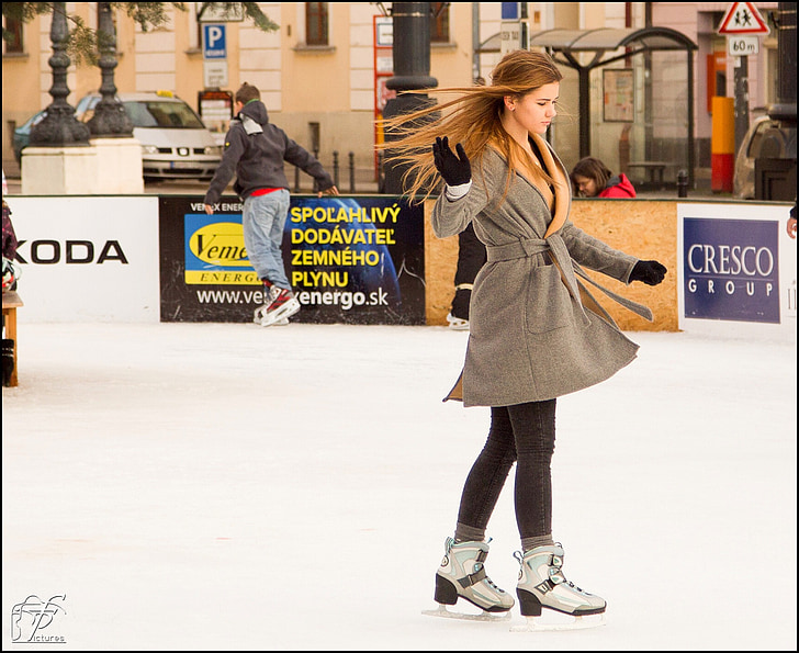 woman skating wearing brown coat