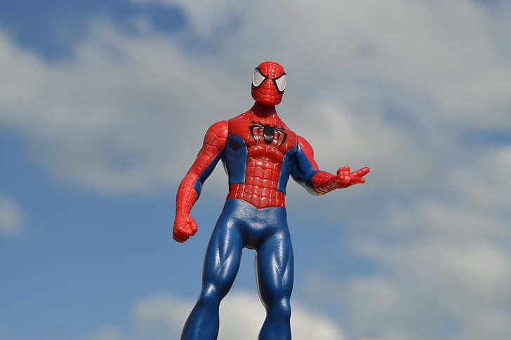 Spider-Man action figure under blue and white cloudy sky