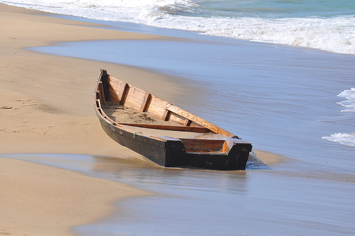 brown jon boat on sea shore