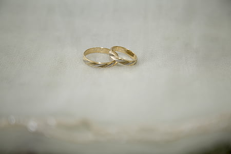 close up photography of two gold-colored rings