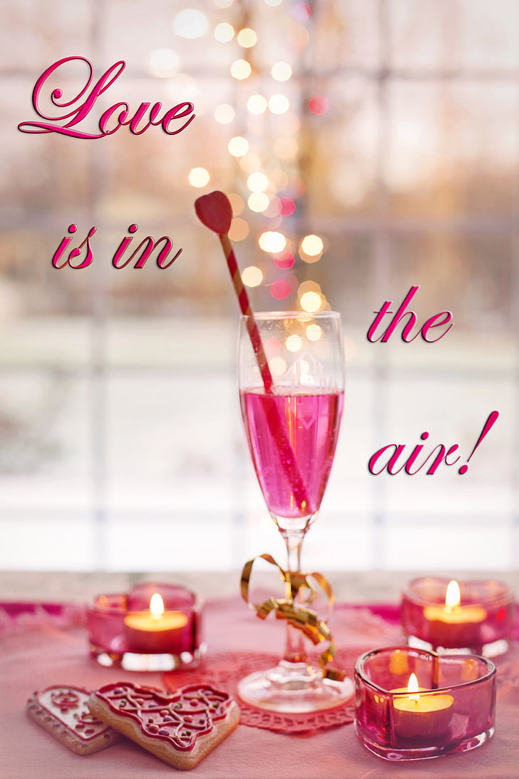 clear wine glass with Love is in the air! text overlay