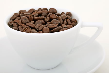 brown coffee beans on white ceramic cup