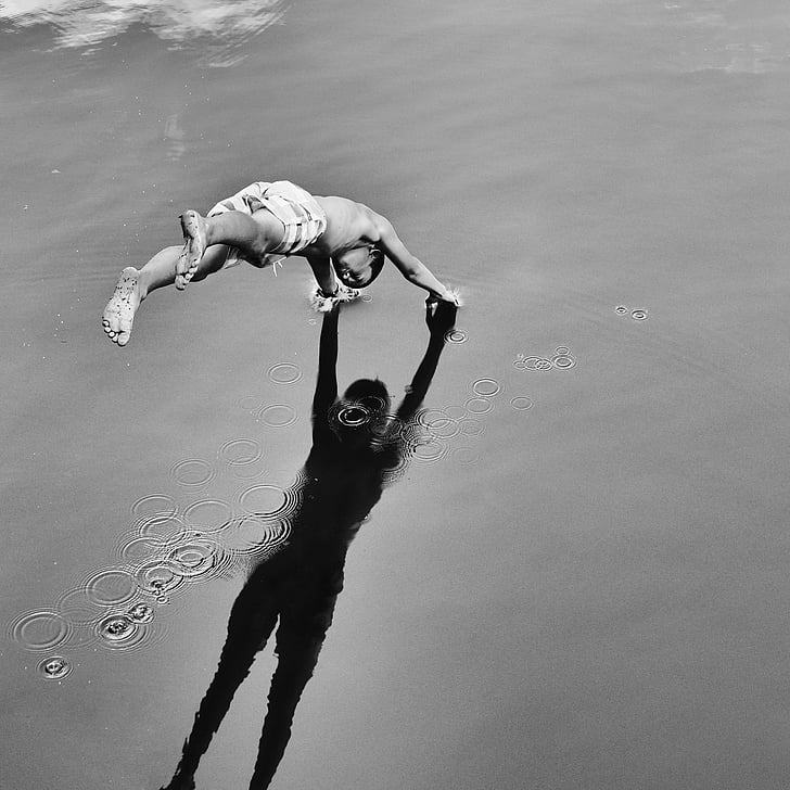 grayscale photography of person diving on water