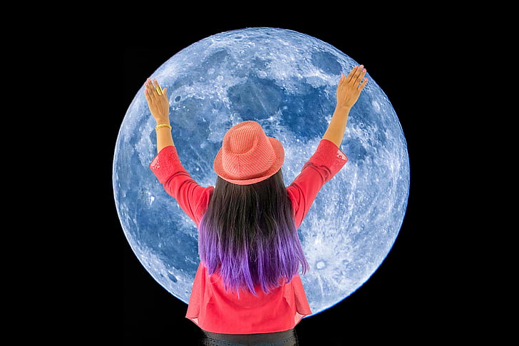 woman holding full moon art