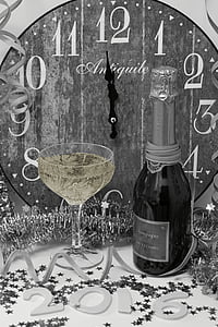 grayscale photography of wine bottle beside wine glass