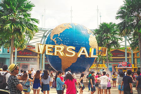 group of people standing near Universal Studios building