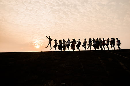 group of people in line during sunset